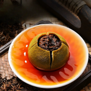 Rich amber liquor of authentic Xinhui citrus puerh tea in a glass gongfu pitcher