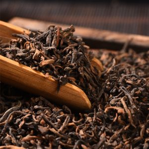 Premium loose leaf ripe pu-erh tea showing uniform brown-red aged shu leaves from a certified Yunnan factory.